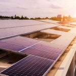 The sun sets on a rooftop solar array.